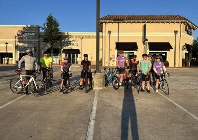 NWCC Vintage Park Starbucks Ride 15 1. Group of cyclists in NWCC cycling jerseys ready for a ride in a shopping center parking lot.