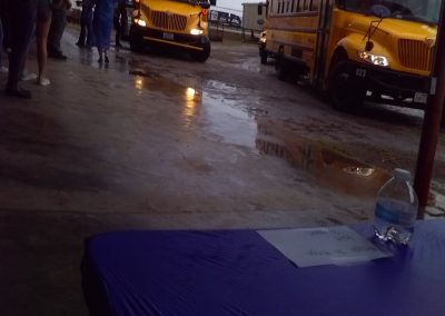 Philanthropy Volunteerism and Charity 4 School bus arrival at a rainy outdoor event; northwest cycling club community gathering.