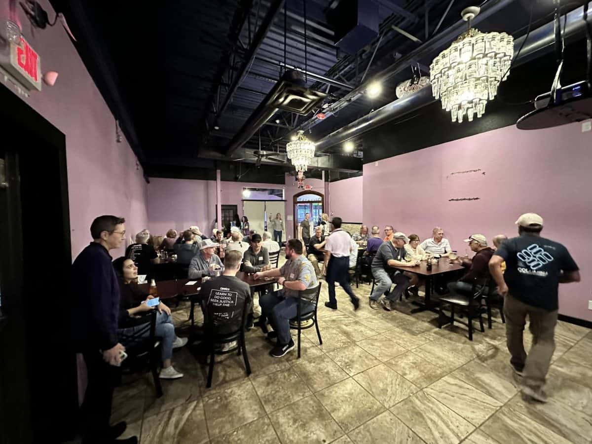 Community indoor event at Northwest Cycling Club with group dining and socializing.
