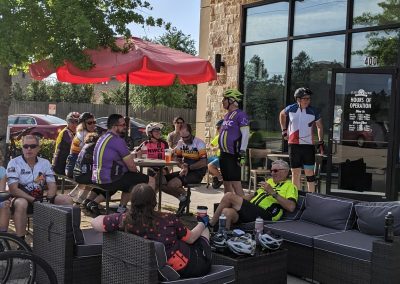 Cyclists gathering outside Northwest Cycling Club for a group ride at a local coffee shop.