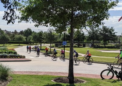 Cyclists riding in a park during daytime, members of Northwest Cycling Club enjoying outdoor biking.