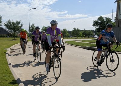 Cycling group riding with Northwest Cycling Club in a suburban neighborhood.