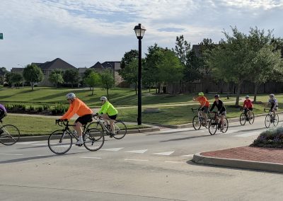 Cycling group riding through neighborhood, Northwest Cycling Club members on scenic bike ride.