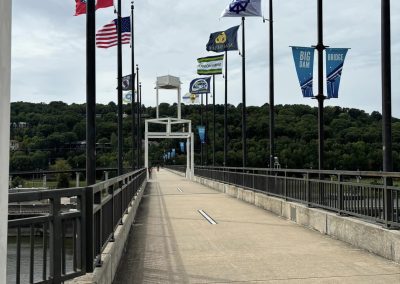 Flags on a bridge over water, promoting Northwest Cycling Club and popular bike routes.