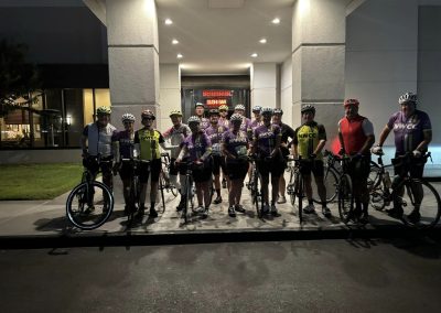 Group of cyclists at night for Northwest Cycling Club ride, showcasing community and cycling enthusiasm.