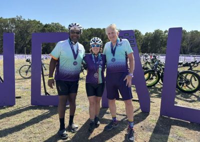 Cycling In Houston - NWCC Recent Activities Gallery 666 Vibrant group of cyclists at Northwest Cycling Club event with bikes and medals in scenic outdoor setting.
