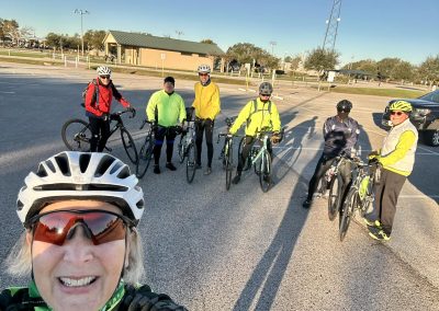 Cycling In Houston - NWCC Recent Activities Gallery 660 Group of cyclists at Northwest Cycling Club ready for a ride, wearing helmets and reflective gear.