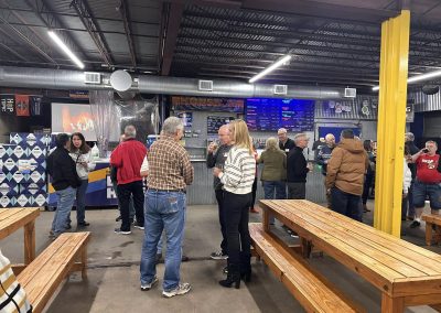 Cycling In Houston - NWCC Recent Activities Gallery 629 People socializing at Northwest Cycling Club indoor event, beer and snacks, community gathering.