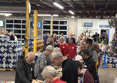 Cycling In Houston - NWCC Recent Activities Gallery 606 Community gathering at Northwest Cycling Club banquet with diverse members enjoying a festive meal indoors.