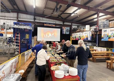 Cycling In Houston - NWCC Recent Activities Gallery 600 Indoor event at Northwest Cycling Club with people serving food in a brewery.