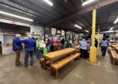 Cycling In Houston - NWCC Recent Activities Gallery 649 Modern indoor event space at Northwest Cycling Club with people browsing booths and holiday decorations.