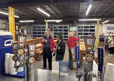 Cycling In Houston - NWCC Recent Activities Gallery 640 Cold beverage taps at Northwest Cycling Club event with members enjoying drinks indoors.