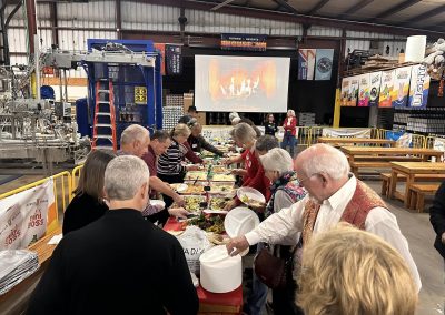 Cycling In Houston - NWCC Recent Activities Gallery 604 People enjoying a communal meal at Northwest Cycling Club event in a large indoor space.