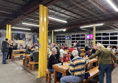 Cycling In Houston - NWCC Recent Activities Gallery 591 Indoor bike club social gathering at Northwest Cycling Club in a spacious, well-lit warehouse-style venue.