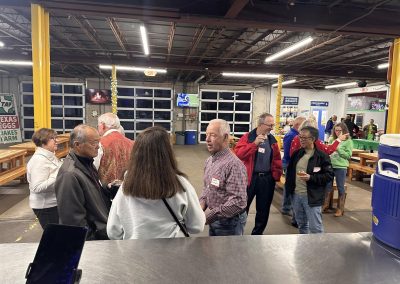 Cycling In Houston - NWCC Recent Activities Gallery 639 People socializing at a cycling club event inside a large indoor venue.