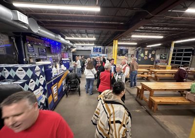 Cycling In Houston - NWCC Recent Activities Gallery 638 Bike shop in Northwest Cycling Club with people enjoying coffee and snacks inside a modern cycling community space.