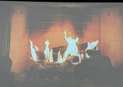 Cycling In Houston - NWCC Recent Activities Gallery 652 Cozy fireplace with flames, ideal for indoor warmth and relaxation.