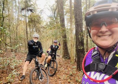 Cycling In Houston - NWCC Recent Activities Gallery 589 Happy cyclists enjoying outdoor mountain biking in the forest with Northwest Cycling Club.