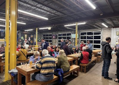 Cycling In Houston - NWCC Recent Activities Gallery 596 People enjoying a group gathering at a lively indoor event space in a brewery or bar setting.