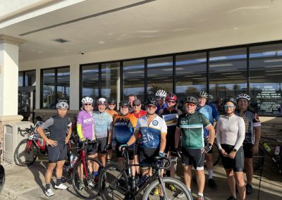Cycling In Houston - NWCC Recent Activities Gallery 588 Group of cyclists gathered outside a building in Northwest Cycling Club attire, ready for a biking adventure.