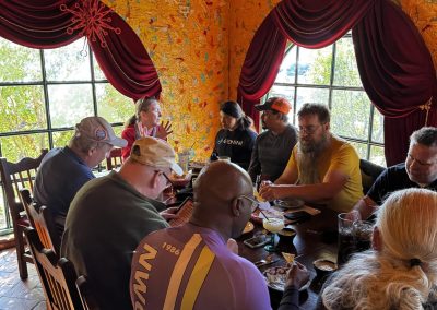 Cycling In Houston - NWCC Recent Activities Gallery 579 Group of cyclists socializing at a cafe, promoting Northwest Cycling Club events and community.