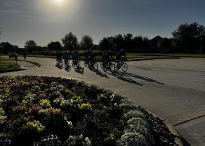 Cycling In Houston - NWCC Recent Activities Gallery 580 Bicyclists riding together in outdoor group cycling event during sunset, showcasing Northwest Cycling Club activities.