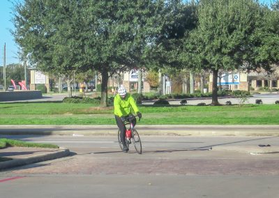 Cycling In Houston - NWCC Recent Activities Gallery 575 Cyclist riding outdoors with safety gear, promoting cycling safety.