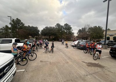 Cycling In Houston - NWCC Recent Activities Gallery 565 Group of cyclists gathering in a parking lot, preparing for a ride with the Northwest Cycling Club.