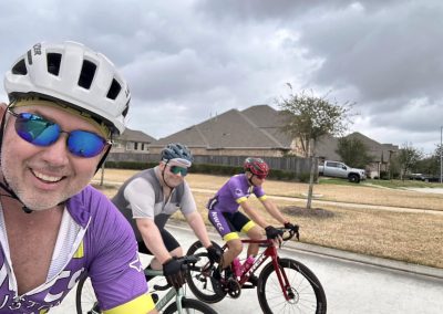 Cycling In Houston - NWCC Recent Activities Gallery 555 Vibrant cycling group participating in a Northwest Cycling Club ride in a suburban neighborhood.