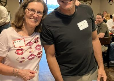 Cycling In Houston - NWCC Recent Activities Gallery 551 Smiling woman and man at Northwest Cycling Club event, enjoying social gathering and community spirit.