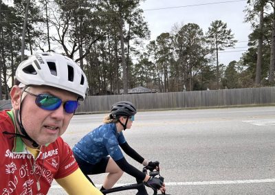 Cycling In Houston - NWCC Recent Activities Gallery 546 Vibrant cyclists participating in Northwest Cycling Club group ride on scenic road.