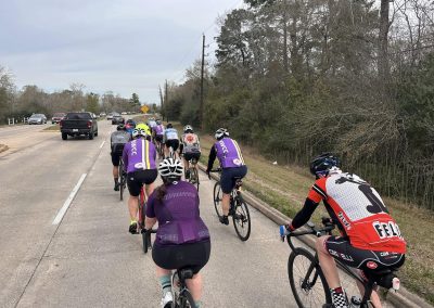 Cycling In Houston - NWCC Recent Activities Gallery 545 Group of cyclists riding together on a scenic road, promoting Northwest Cycling Club and community cycling.