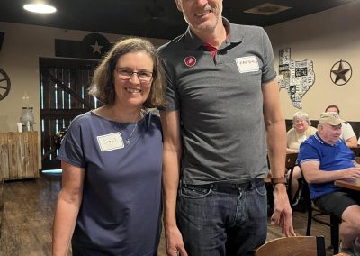 Cycling In Houston - NWCC Recent Activities Gallery 540 1. Smiling members of Northwest Cycling Club at indoor event, showcasing community and camaraderie.