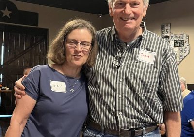 Cycling In Houston - NWCC Recent Activities Gallery 538 Smiling woman and man at Northwest Cycling Club event, wearing name tags, indoor gathering, community cycling enthusiasts.
