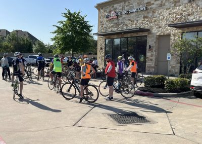 Cycling In Houston - NWCC Recent Activities Gallery 525 Cycling group gathering at Northwest Cycling Club event outside a coffee shop in Texas.