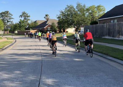 Cycling In Houston - NWCC Recent Activities Gallery 522 Group of cyclists riding through residential neighborhood during Northwest Cycling Club ride.