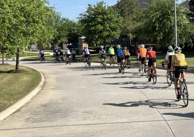 Cycling In Houston - NWCC Recent Activities Gallery 526 Group of cyclists riding on a suburban street with trees, part of Northwest Cycling Club.