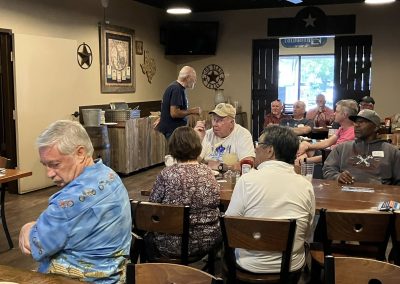 Cycling In Houston - NWCC Recent Activities Gallery 529 Busy indoor scene of Northwest Cycling Club members gathering at a restaurant or bar, enjoying camaraderie after cycling events.