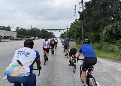 Cycling In Houston - NWCC Recent Activities Gallery 510 Vivid group cycling tour along scenic roadway with Northwest Cycling Club, emphasizing community and outdoor adventure.