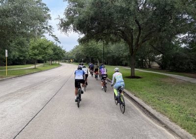 Cycling In Houston - NWCC Recent Activities Gallery 508 Bike ride with group of cyclists on suburban street promoting Northwest Cycling Club outdoor recreation.