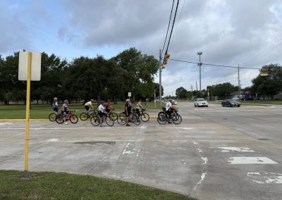 Cycling In Houston - NWCC Recent Activities Gallery 488 Biking group crossing the street during Northwest Cycling Club ride in urban area.