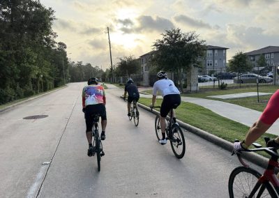 Cycling In Houston - NWCC Recent Activities Gallery 501 Cyclists riding together on a neighborhood street during a Northwest Cycling Club group ride.