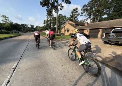 Cycling In Houston - NWCC Recent Activities Gallery 499 Cyclists riding together in a suburban neighborhood, promoting community cycling with Northwest Cycling Club.