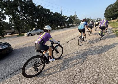 Cycling In Houston - NWCC Recent Activities Gallery 478 Cyclists riding on a scenic road with trees, part of Northwest Cycling Club's community rides.