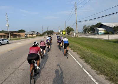 Cycling In Houston - NWCC Recent Activities Gallery 476 Riding group of cyclists on a scenic road, promoting outdoor activity with Northwest Cycling Club.