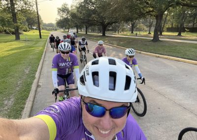 Cycling In Houston - NWCC Recent Activities Gallery 483 Vibrant cyclists group ride with Northwest Cycling Club in scenic park; promoting fitness and community.