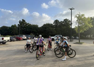 Cycling In Houston - NWCC Recent Activities Gallery 458 Cycling club members gathering in parking lot for group ride, outdoor biking event.