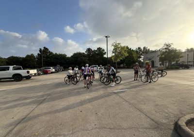 Cycling In Houston - NWCC Recent Activities Gallery 457 Group of cyclists gathering in parking lot for Northwest Cycling Club ride, outdoor biking event.