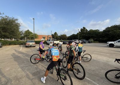 Cycling In Houston - NWCC Recent Activities Gallery 460 Group of cyclists gathering in a parking lot for Northwest Cycling Club ride, outdoor cycling, biking activity.
