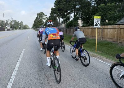 Cycling In Houston - NWCC Recent Activities Gallery 465 Group of cyclists riding on a city street, promoting active lifestyle and community biking.
